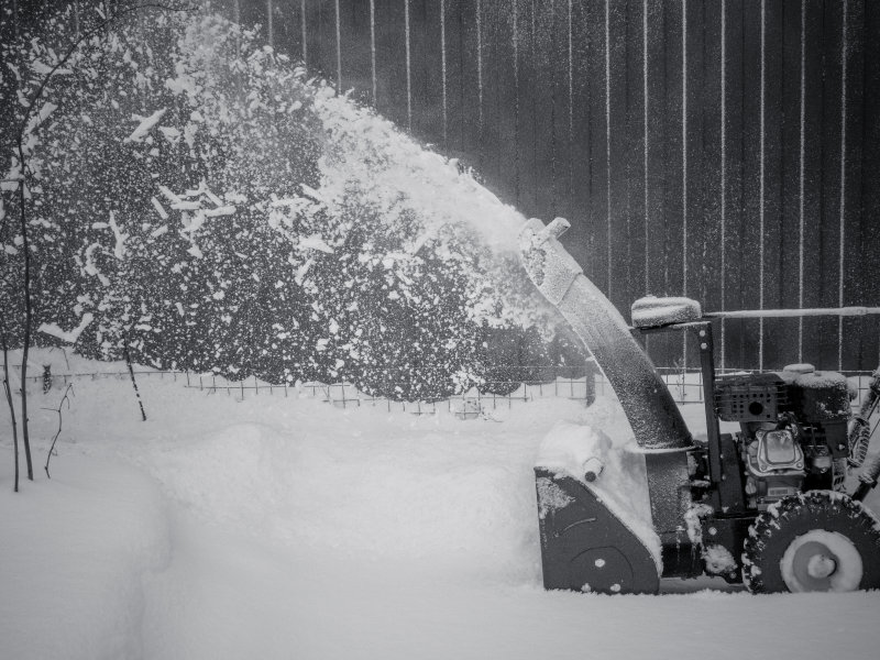 Crew clearing snow on commercial building steps